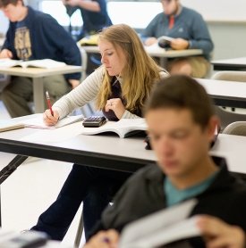 A student works on a math problem in class