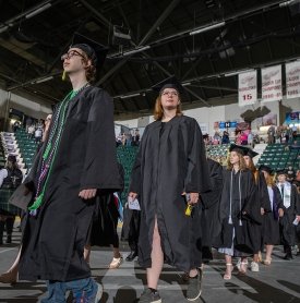 Graduates walk into commencement