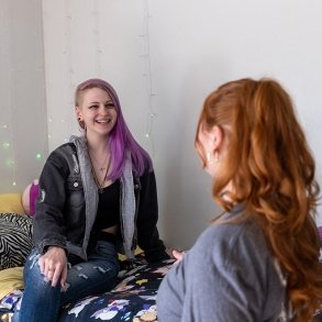 Two students talking in a dorm room 