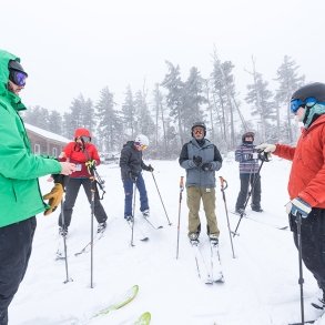 Students learning to downhill ski 