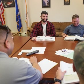 Veterans sitting around a table talking and laughing