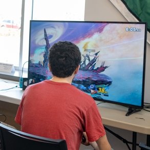 A young man plays a video game at Nerd Fest