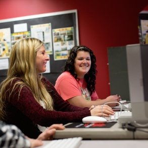 Students laugh as they work in a Media Arts lab