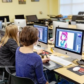 Students use computers in an on-campus Mac lab