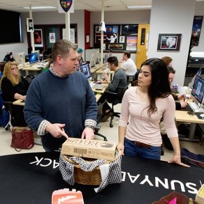 Professor Nick Paigo works with a student in a Media Arts course