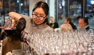 A Culinary student pours wine at Vintners Night at Seasoned