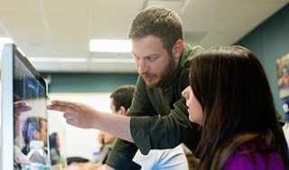 Photography instructor Brandon Segal explains a concept to a student