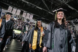 Graduates walk into commencement