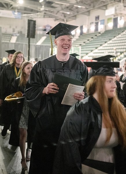 Emil Gustafsson smiles as he walks into graduation