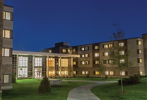 Exterior image of the residence hall in the evening