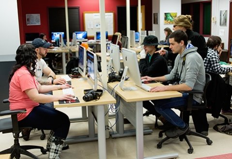 Now-retired photography professor Renee O'Brien leads a class in a Mac lab