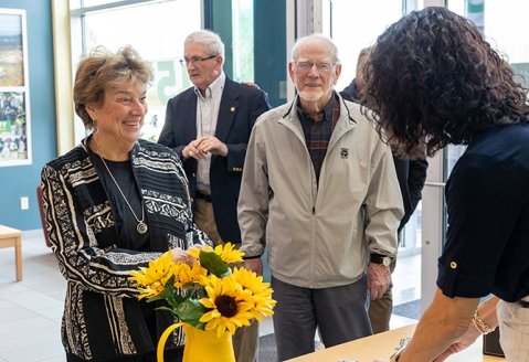 Event attendees being welcomed into the front entrance of the Saratoga campus