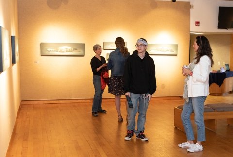 Students and faculty viewing art in the gallery