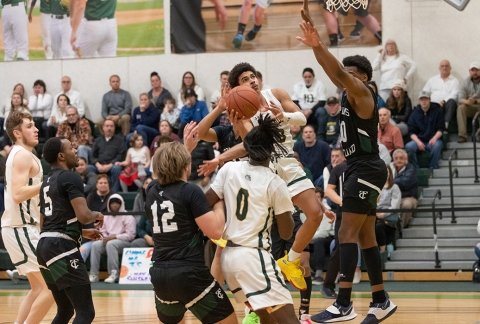 Men's basketball team going up for a shot