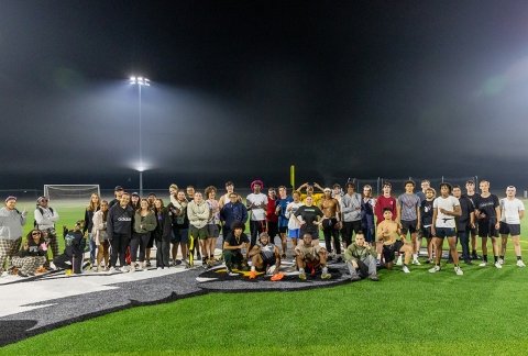 Intramural football students on the turf under the lights