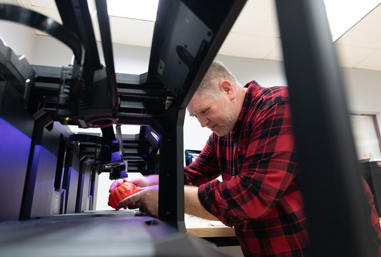 Professor Nick Paigo working with the 3d printers in the makerspace